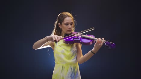 Young-beautiful-musician-woman-playing-the-violin.